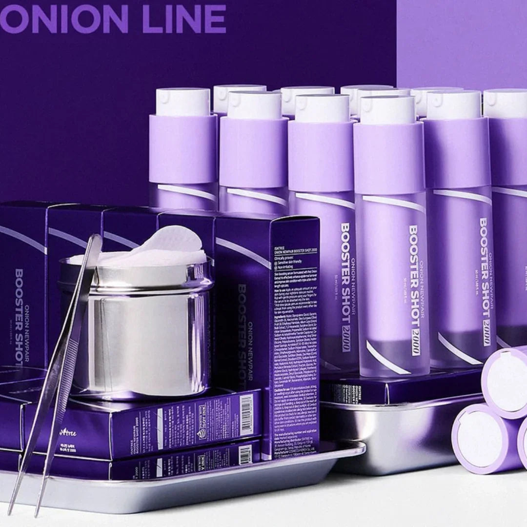 Purple bottles and boxes of Isntree Onion Newpair Booster Shot skincare product with cotton pads and tweezers on a tray