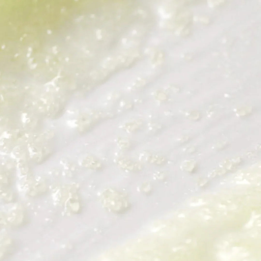 Close-up texture of moist white and pale yellow skincare cream with bubbles